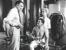 Walter Pidgeon, Robert Sterling and Barbara Eden in the missile room.