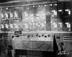 Production record photo of plotting stand and control room computer.