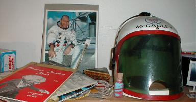 That's an autographed photo of astronaut Alan Bean next to Colonel McCauley's helmet.